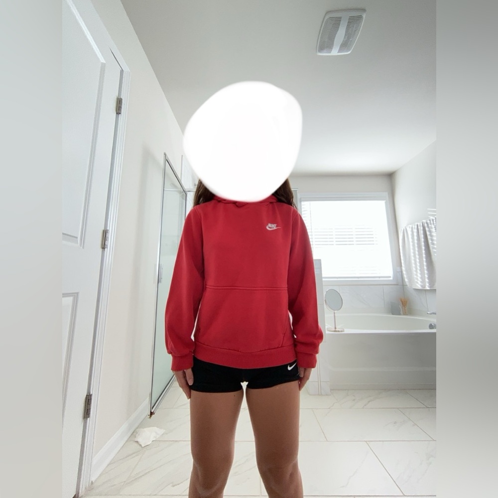 A red “big kids” Nike hoodie